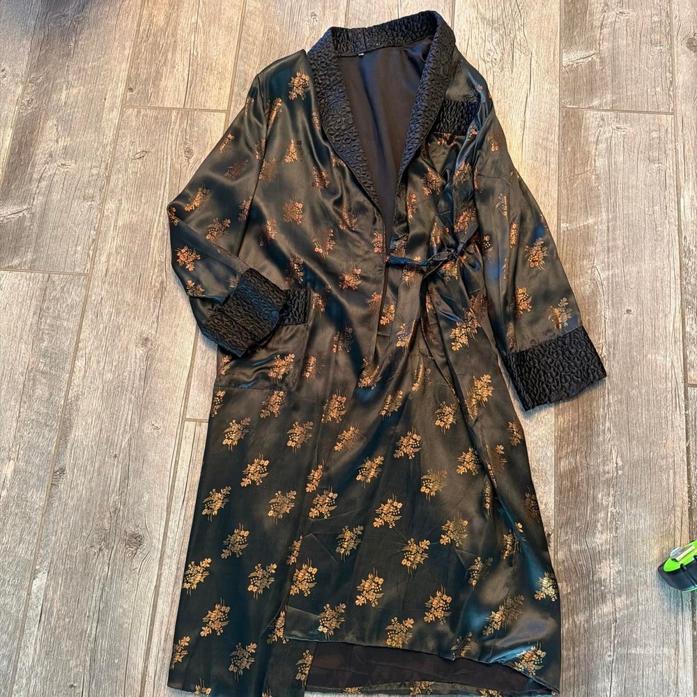Full-length black satin-look robe with scattered gold floral motifs, textured